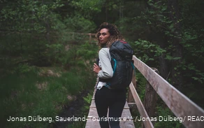 Wandererin auf dem Holzsteg in den Ebbemooren